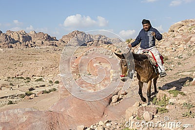 Petra, Jordan â€“ December 24th, 2015: Bedouin man riding a horse Editorial Stock Photo